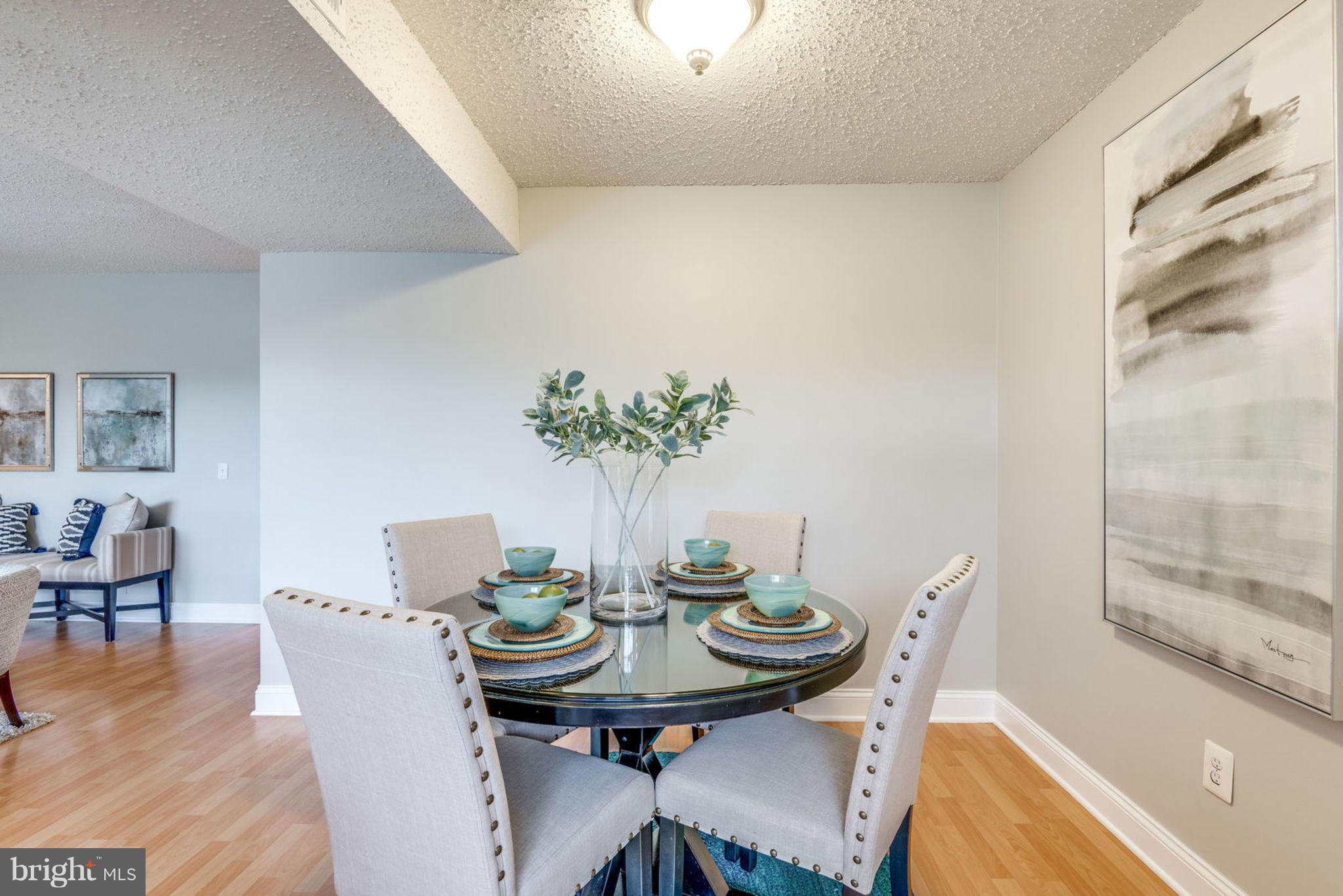 104 Fort Evans Road Southeast, Unit A Leesburg, VA 20175 - Photo 10 of 24 a view of a dining room with furniture and wooden floor