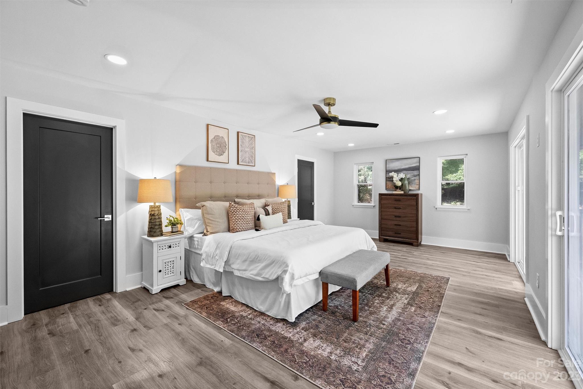 4600 Rounding Run Road Charlotte, NC 28277 - Photo 15 of 33 a bedroom with a large bed and a chandelier