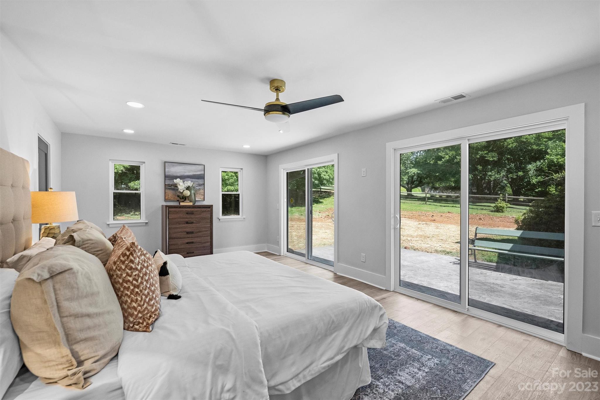 4600 Rounding Run Road Charlotte, NC 28277 - Photo 16 of 33 a bedroom with a large bed and a chandelier