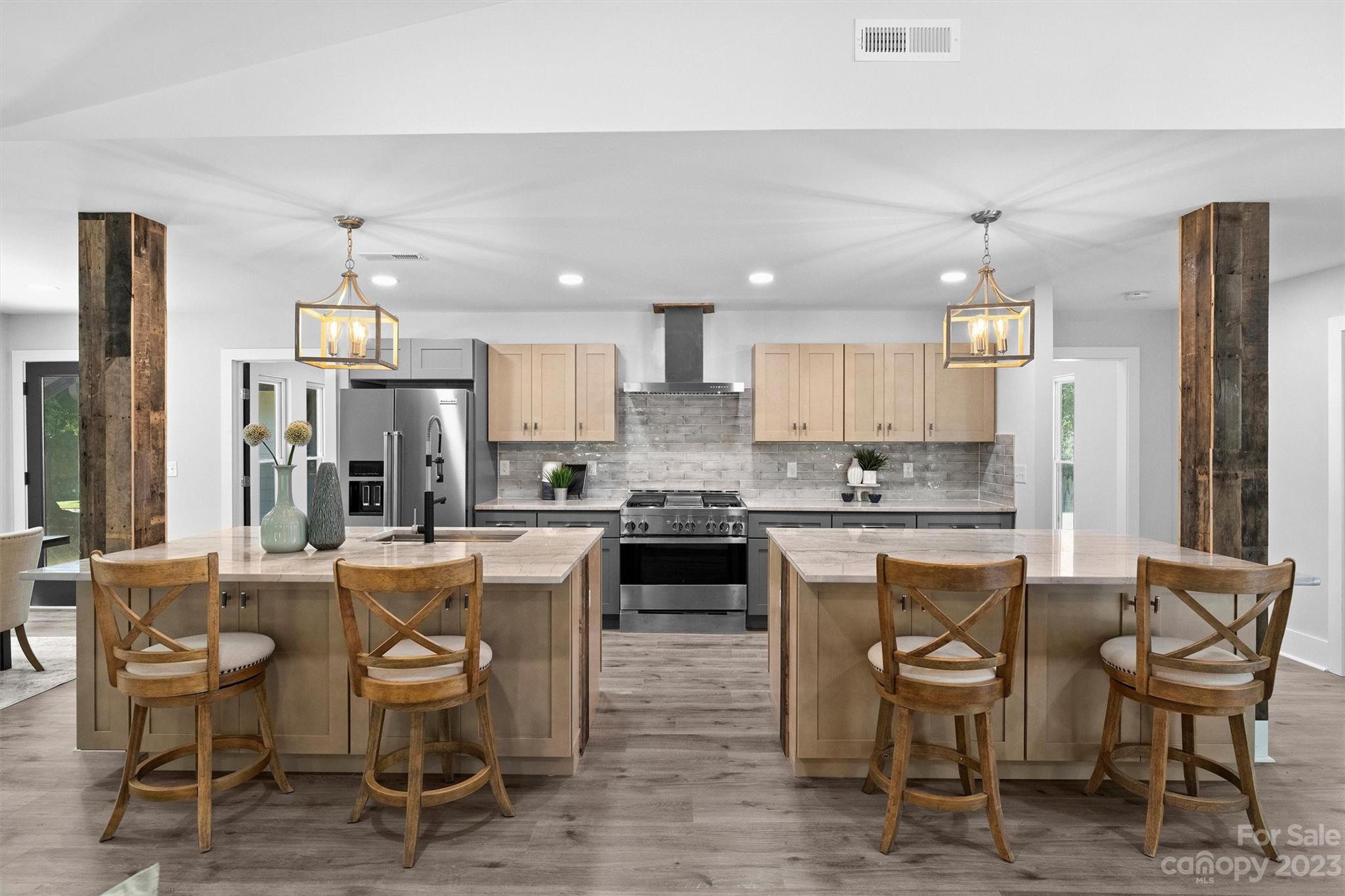 4600 Rounding Run Road Charlotte, NC 28277 - Photo 3 of 33 a kitchen with a dining table chairs refrigerator and cabinets