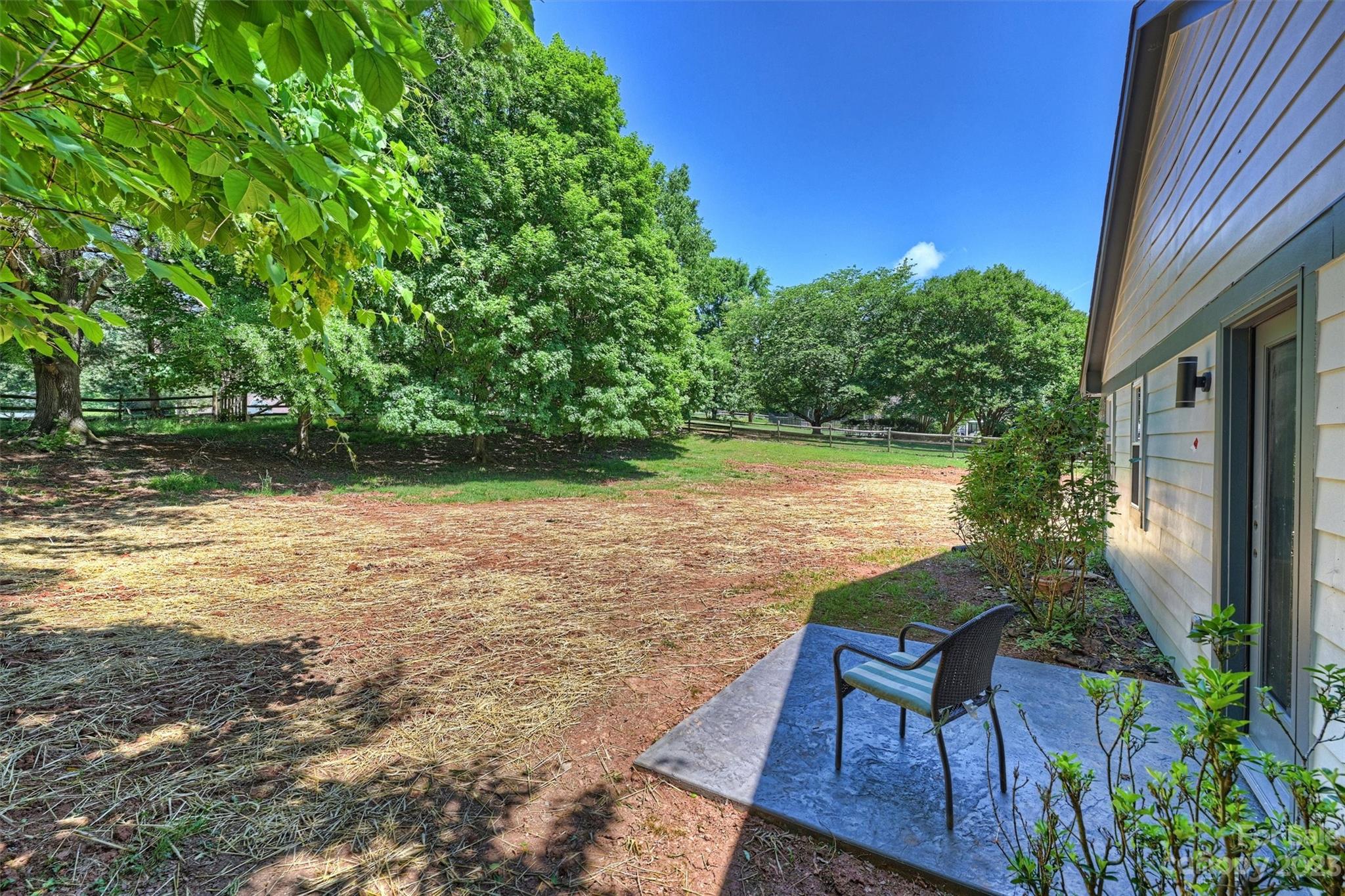 4600 Rounding Run Road Charlotte, NC 28277 - Photo 32 of 33 a view of a lake with table and chairs potted plants and large tree