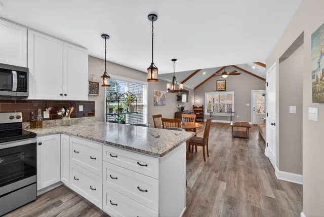 a kitchen with sink cabinets and wooden floor