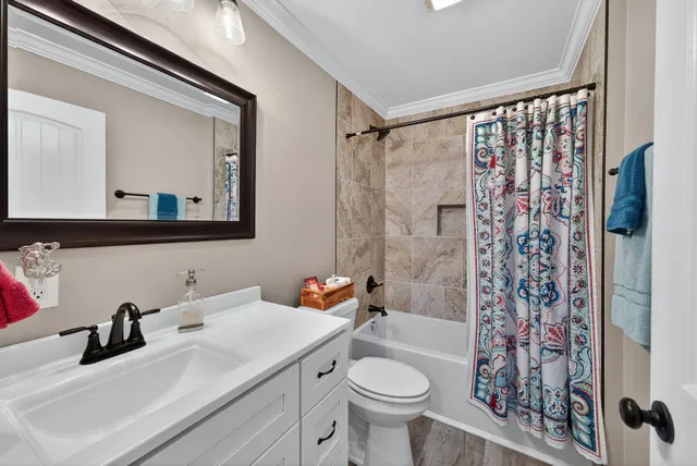 a bathroom with a sink toilet a mirror a vanity and shower