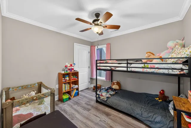 a bed room with a bed and a chandelier