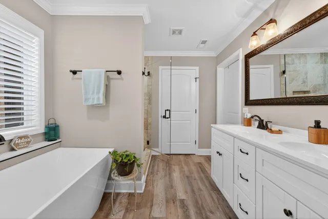 a spacious bathroom with a granite countertop tub sink and mirror