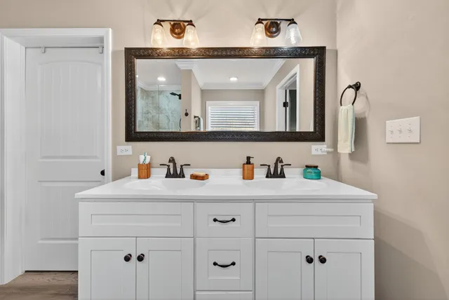 a bathroom with a sink vanity and mirror