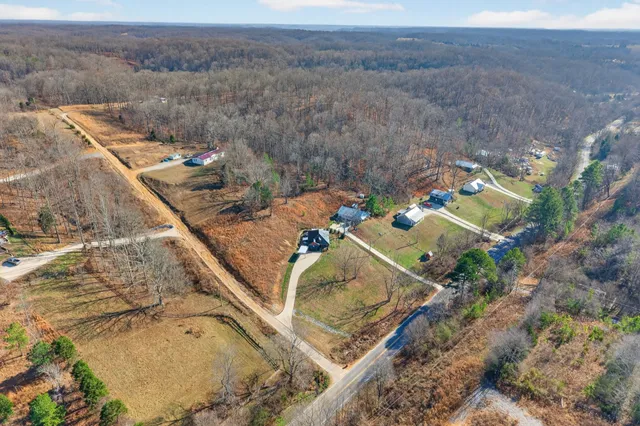an aerial view of a house with a yard and lake view