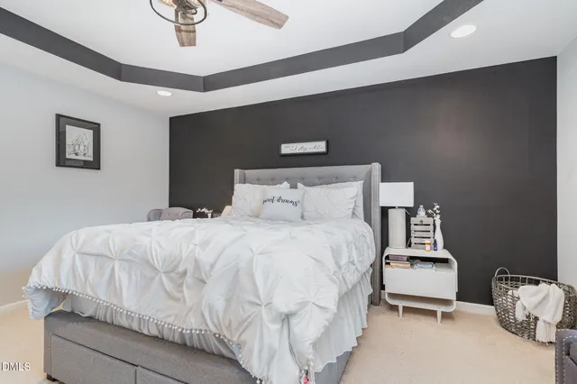 a bedroom with a bed and lamp