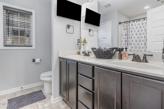 a bathroom with a sink toilet a mirror and shower