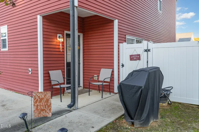 a view of a backyard with a chair and a barbeque
