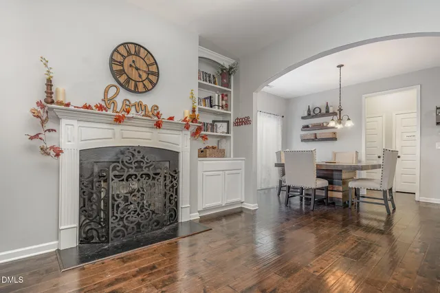a living room with furniture a table and a fireplace