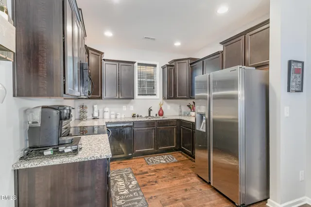 a kitchen with refrigerator and cabinets