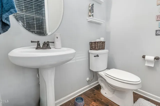 a bathroom with a sink toilet and a mirror
