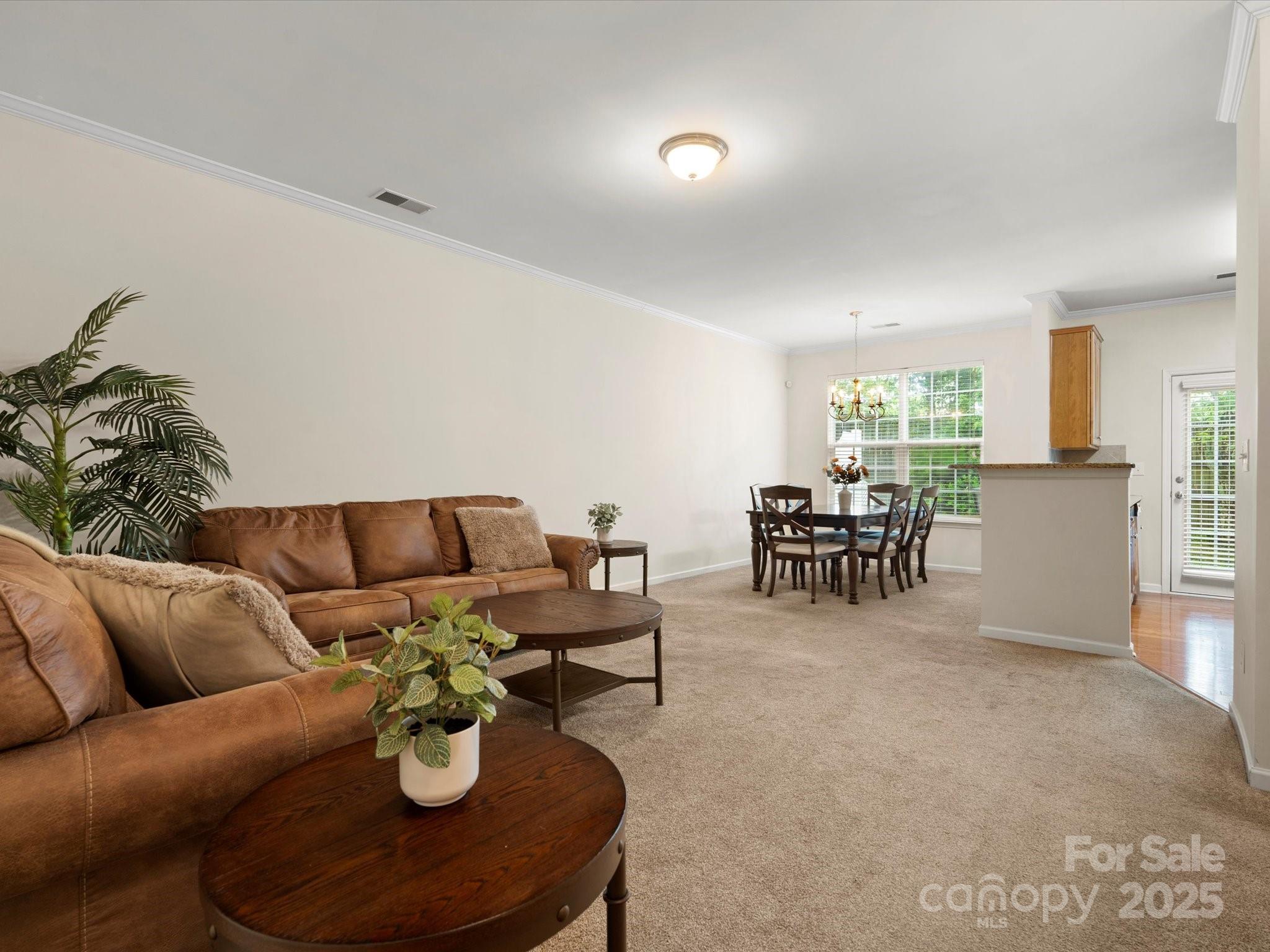 2137 Midnight Blue Lane Fort Mill, SC 29708 - Photo 11 of 40 a living room with furniture and a dining table with kitchen view