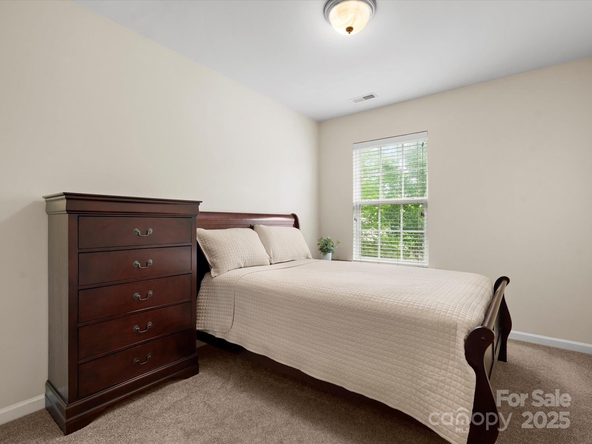 2137 Midnight Blue Lane Fort Mill, SC 29708 - Photo 23 of 40 a bedroom with a bed and a window