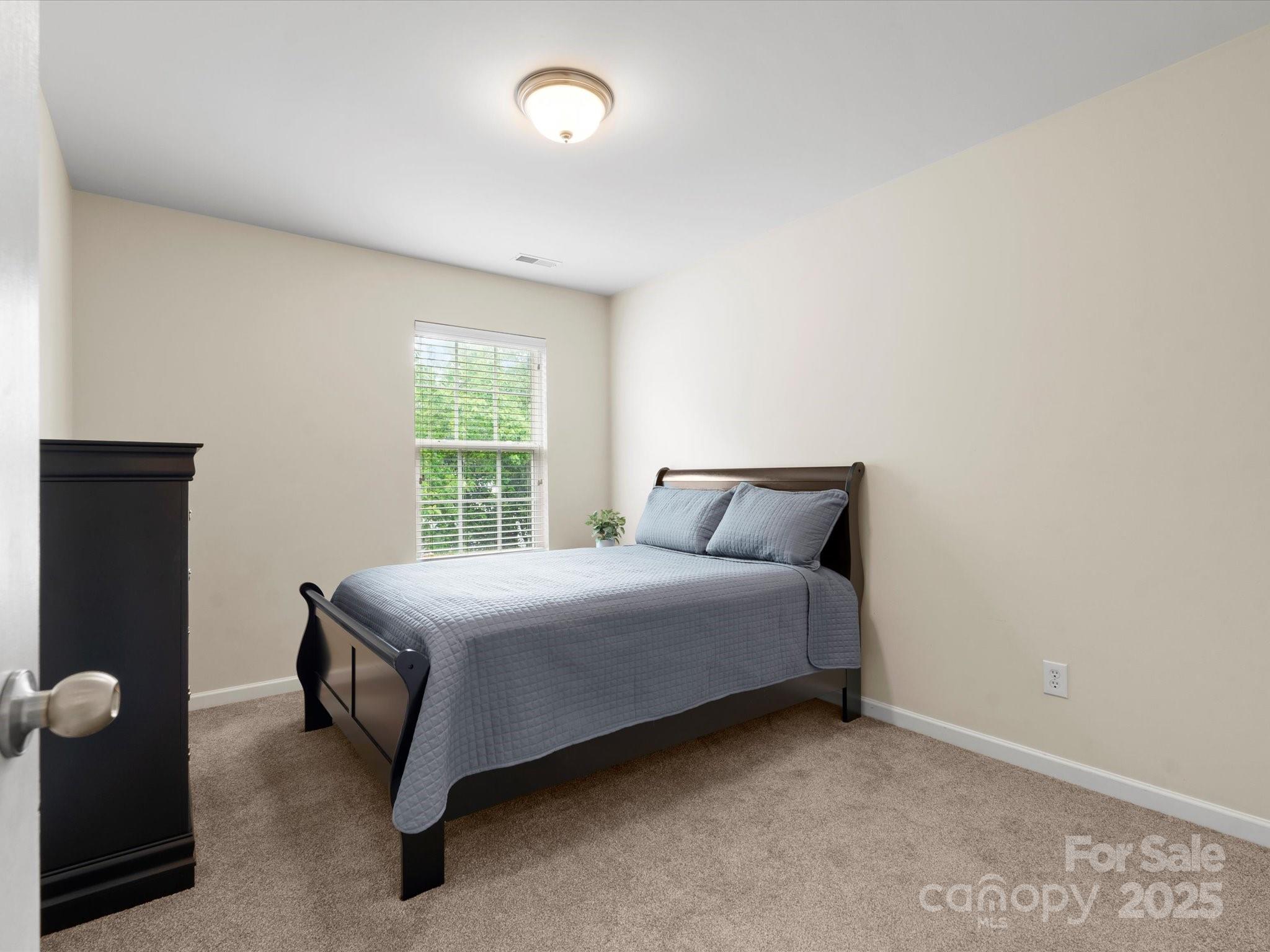 2137 Midnight Blue Lane Fort Mill, SC 29708 - Photo 25 of 40 a bed sitting in a room next to a window