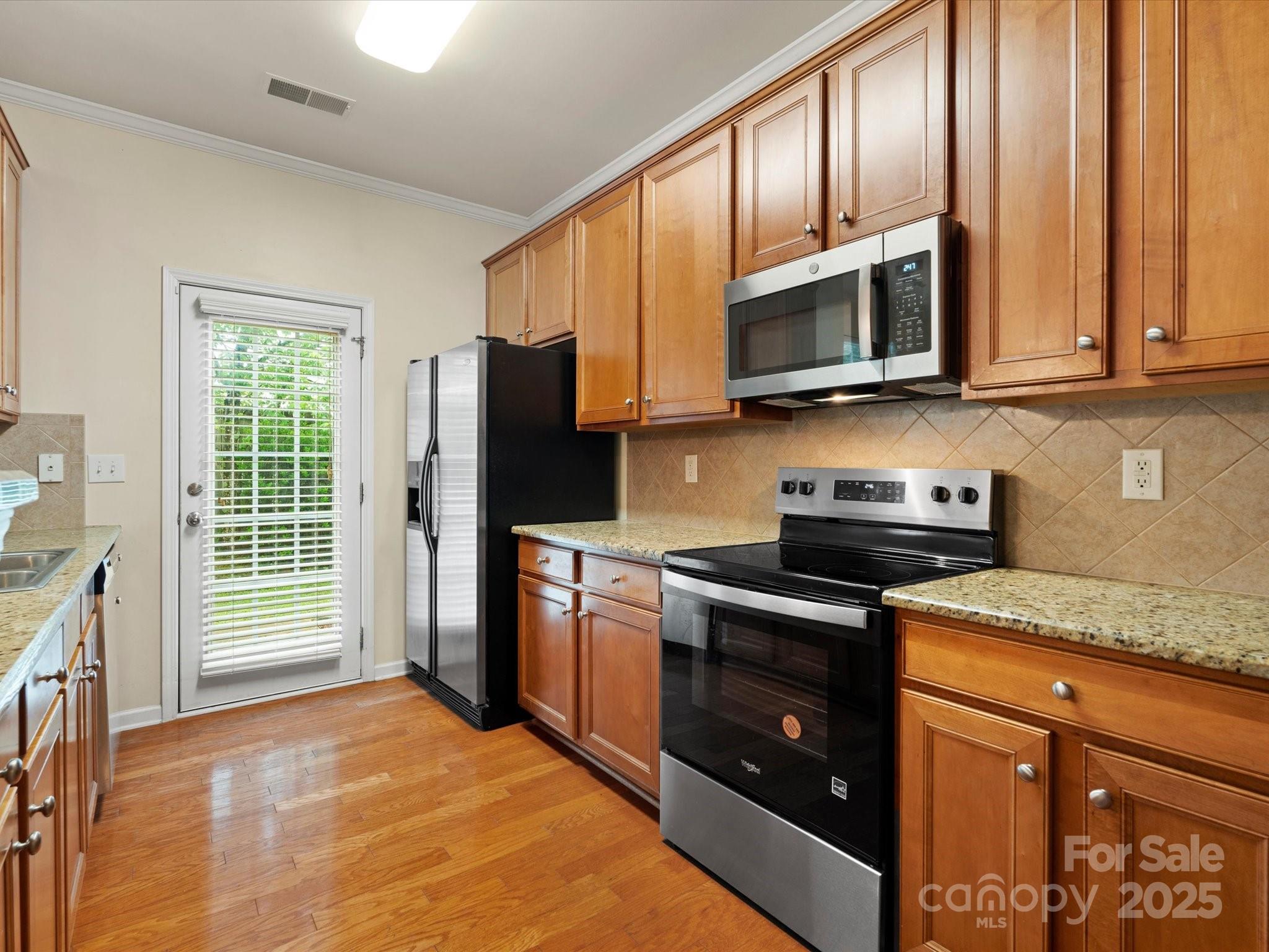 2137 Midnight Blue Lane Fort Mill, SC 29708 - Photo 7 of 40 a kitchen with stainless steel appliances granite countertop a stove sink microwave and refrigerator