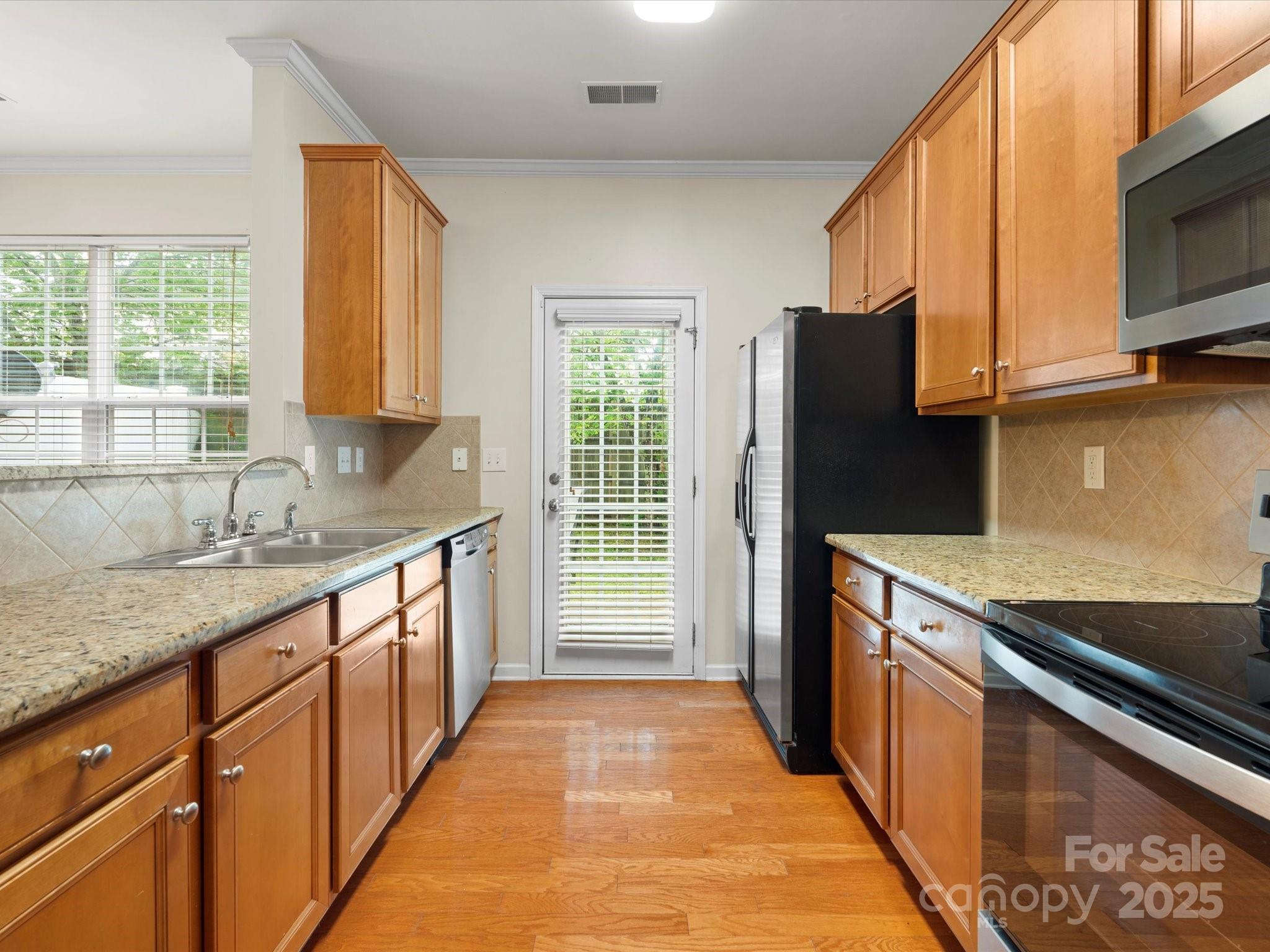 2137 Midnight Blue Lane Fort Mill, SC 29708 - Photo 8 of 40 a kitchen with stainless steel appliances granite countertop a sink and a refrigerator