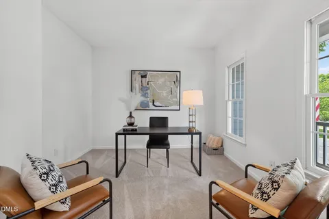 a view of a dining room with furniture and window