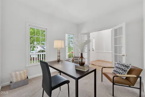 a living room with furniture wooden floor and a large window