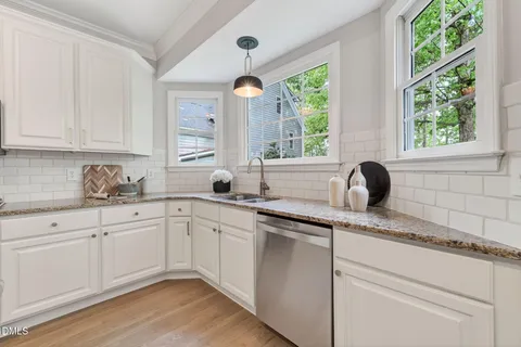 a spacious bathroom with a granite countertop tub sink a mirror and a bathtub