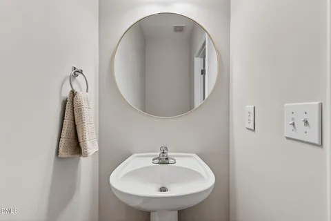 a view of a small space with wooden floor and a window