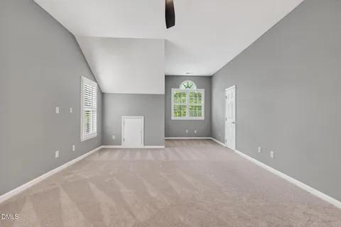 a view of an empty room and wooden floor
