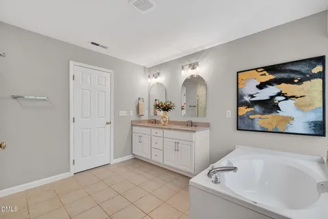 a bathroom with a sink a mirror and a window