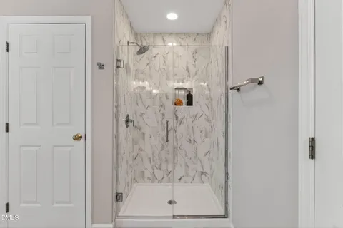 a bathroom with a glass shower door