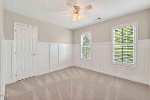 a view of a backyard with table and chairs under an umbrella