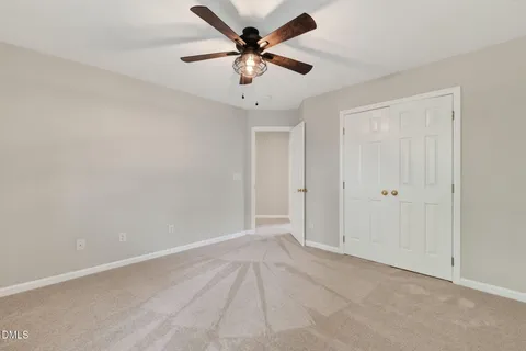 a front view of a house with a garden and yard