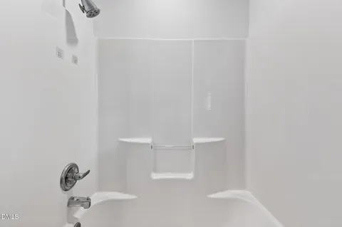 an aerial view of a house with garden space and a street view