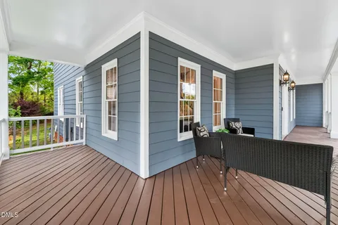 a view of a deck with couches with wooden floor and fence
