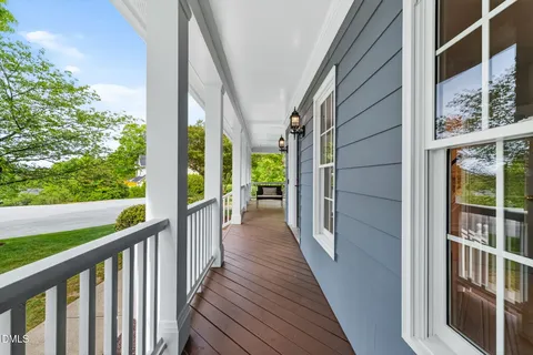 a view of a balcony with wooden floor