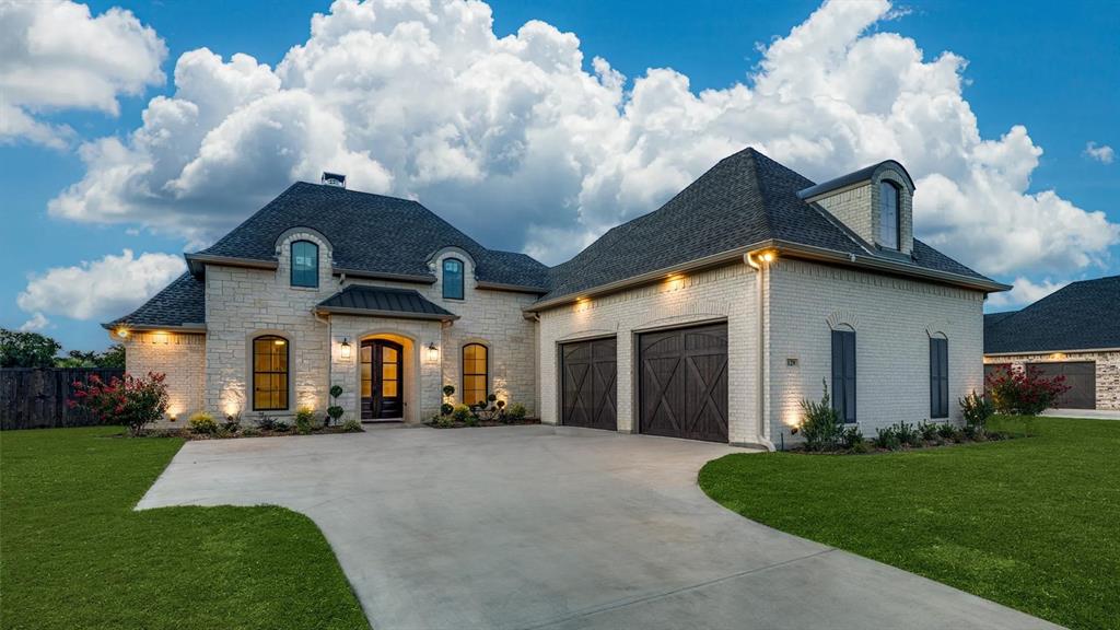129 Old Bridge Road Waxahachie, TX 75165 - Photo 1 of 8 French country home featuring driveway, a garage, a shingled roof, and brick siding