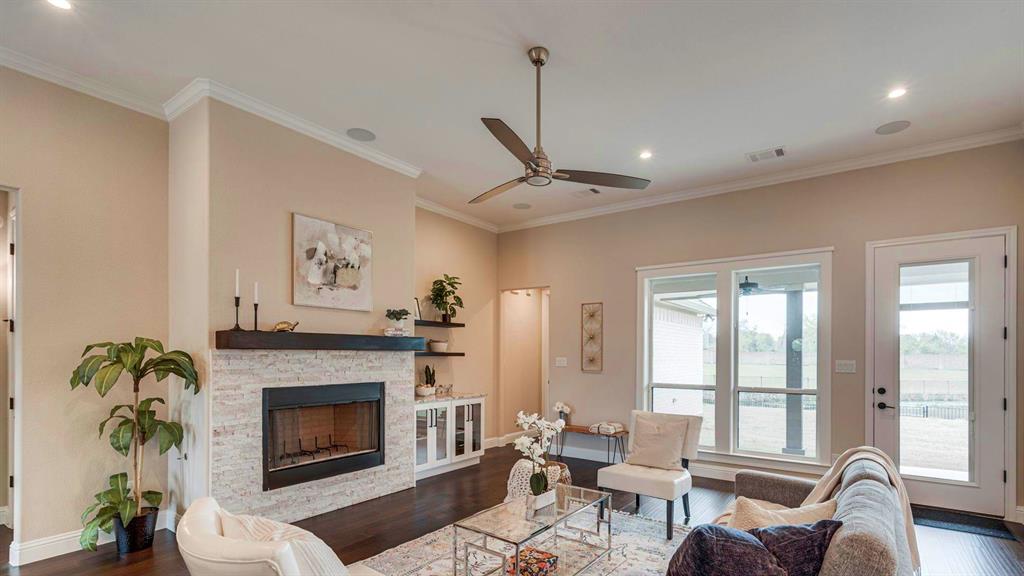 129 Old Bridge Road Waxahachie, TX 75165 - Photo 2 of 8 Living room with dark wood-style floors, a stone fireplace, crown molding, recessed lighting, and ceiling fan