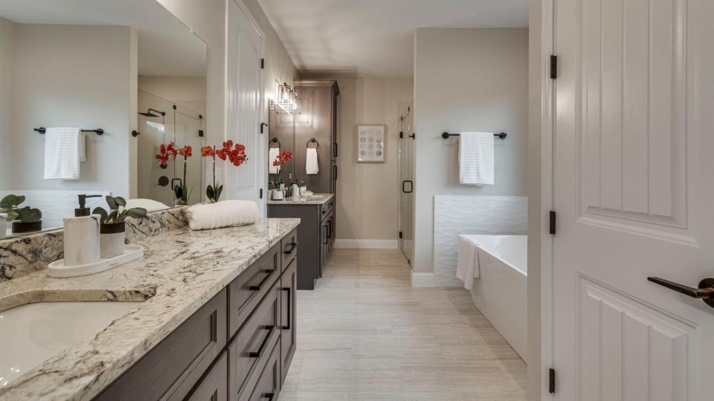 129 Old Bridge Road Waxahachie, TX 75165 - Photo 4 of 8 Full bathroom featuring a stall shower, two vanities, and a tub to relax in