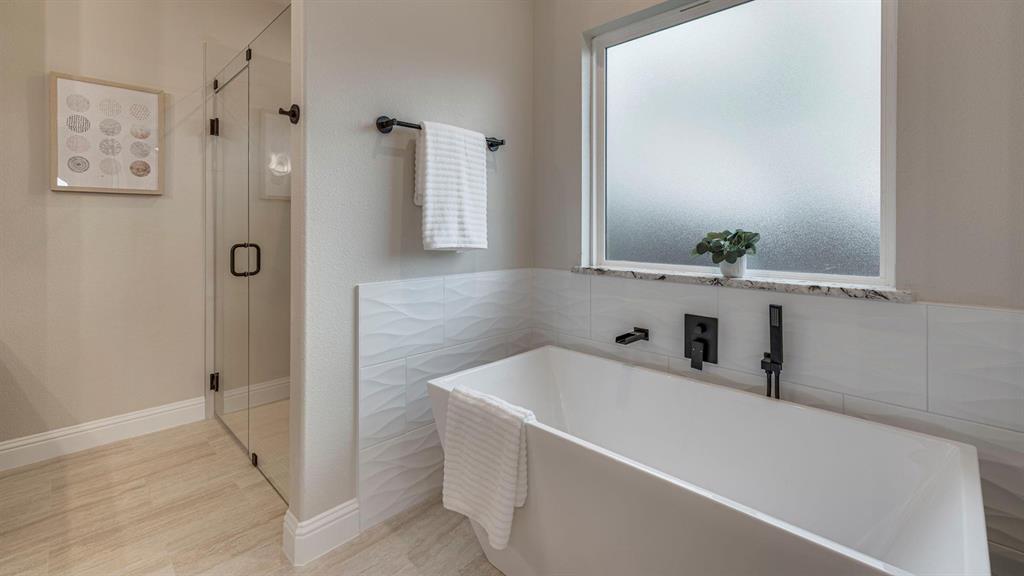 129 Old Bridge Road Waxahachie, TX 75165 - Photo 5 of 8 Full bath featuring a stall shower, a freestanding tub, and light wood-type flooring