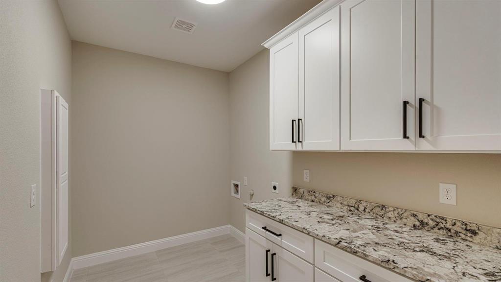 129 Old Bridge Road Waxahachie, TX 75165 - Photo 7 of 8 Laundry area with electric dryer hookup, cabinet space, and hookup for a washing machine