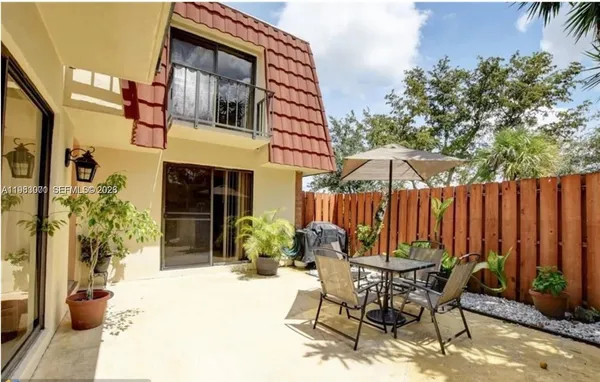 a view of a house with backyard and sitting area