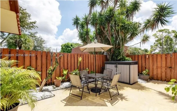 a view of balcony with wooden floor and fence