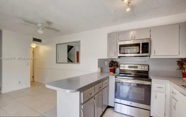 a kitchen with a stove and a microwave