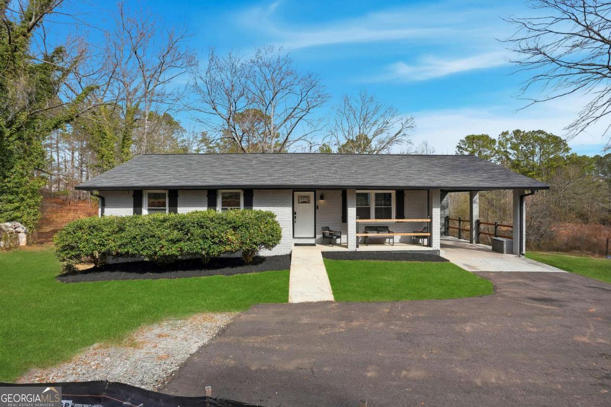a front view of house with yard patio and green space
