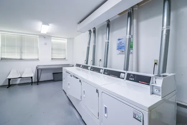 a bathroom with a double vanity sink mirror and bathtub