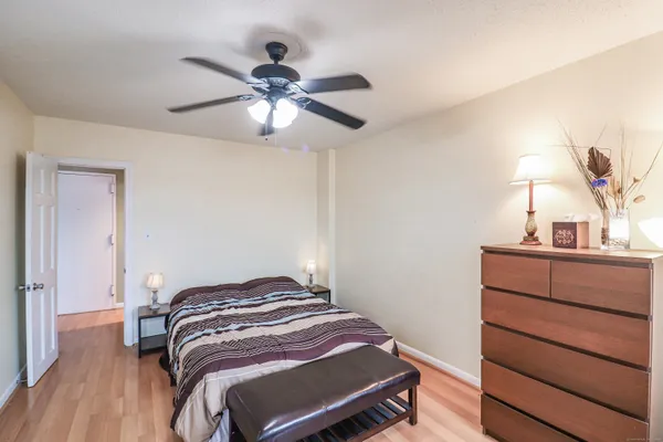 a bedroom with a bed and wooden floor