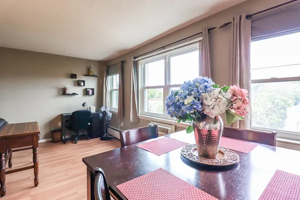 a view of a dining room with furniture window and wooden floor