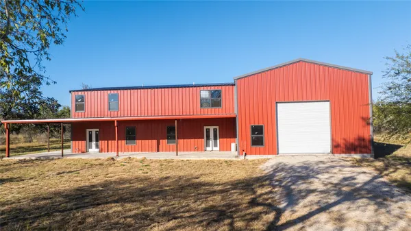 a front view of a house with large windows