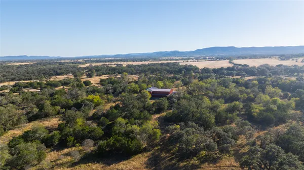 an aerial view of mountain with trees in the background