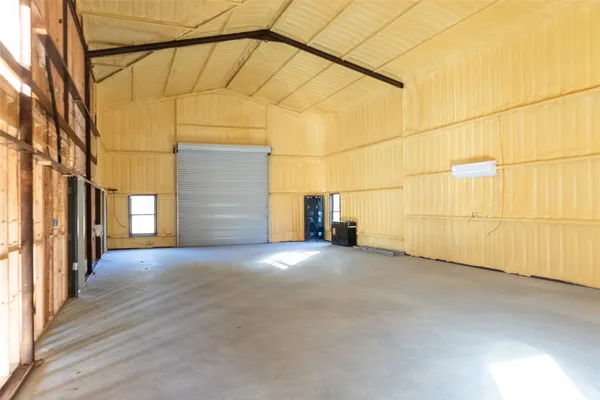 an empty room with a empty space and windows