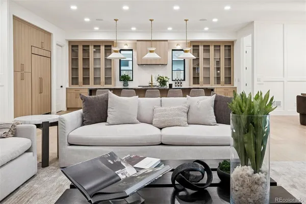 a living room with furniture kitchen and a table